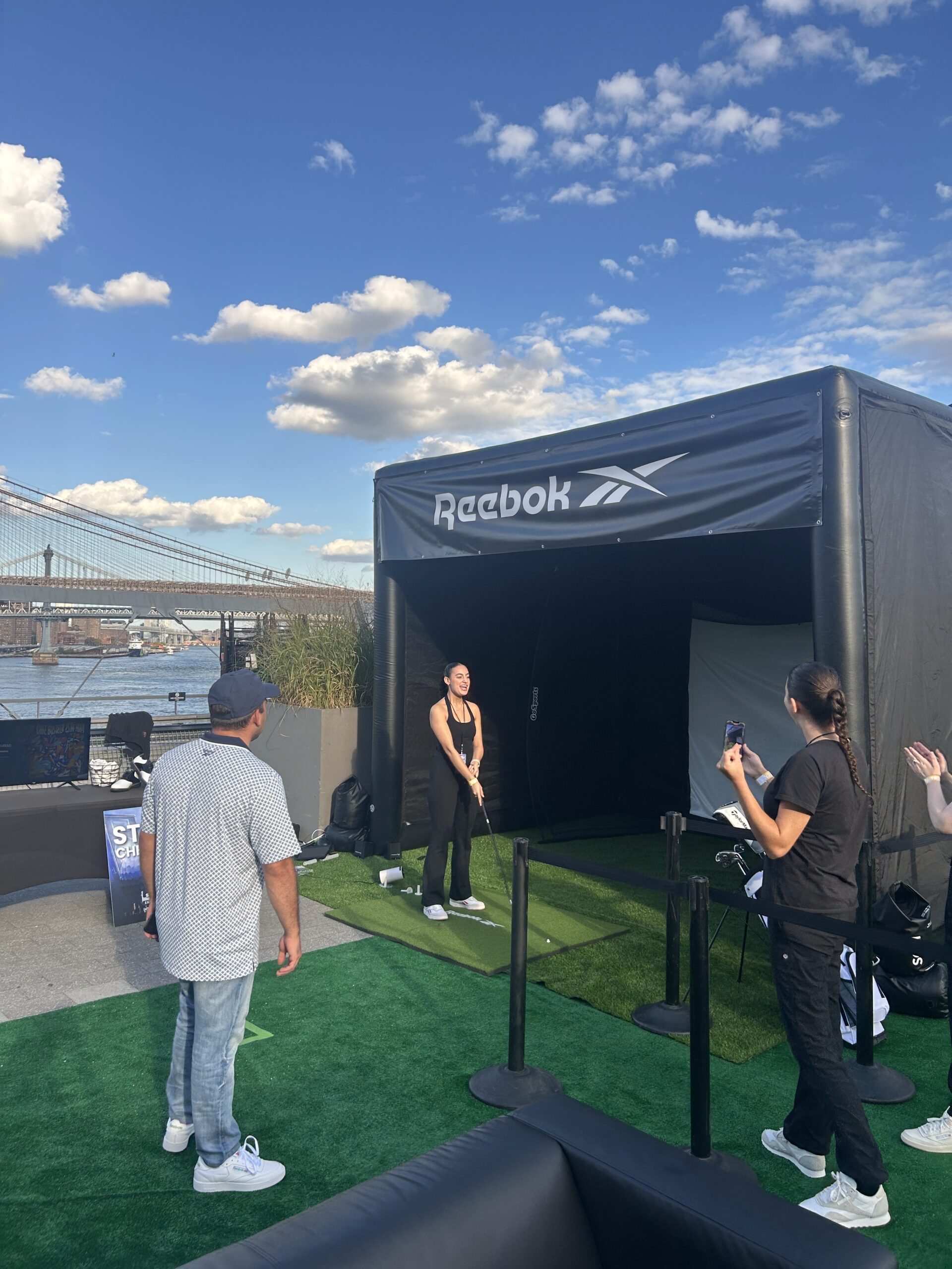 Individual preparing to swing a golf club in a ParTee Golf simulator